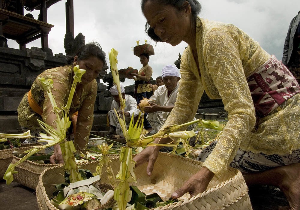 Villagers and priests prepare a complex array of offerings for an odalan, or Hindu temple festival, in Trunyan, Kintamani, Bali