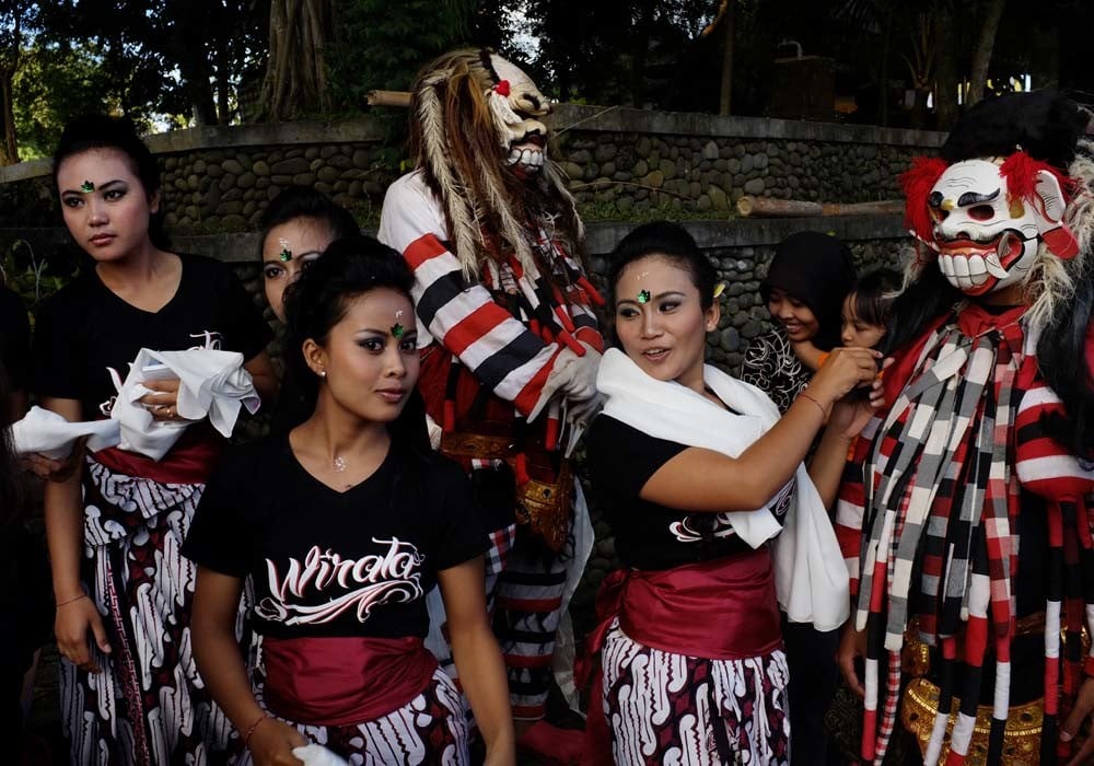 Balinese girls and monsters prepare for Ngerupuk in Ubud, Bali