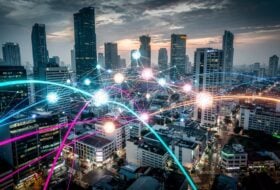 Abstract data network over Southeast Asian city skyline at dusk