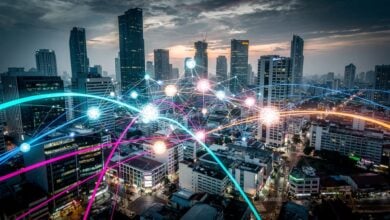 Abstract data network over Southeast Asian city skyline at dusk