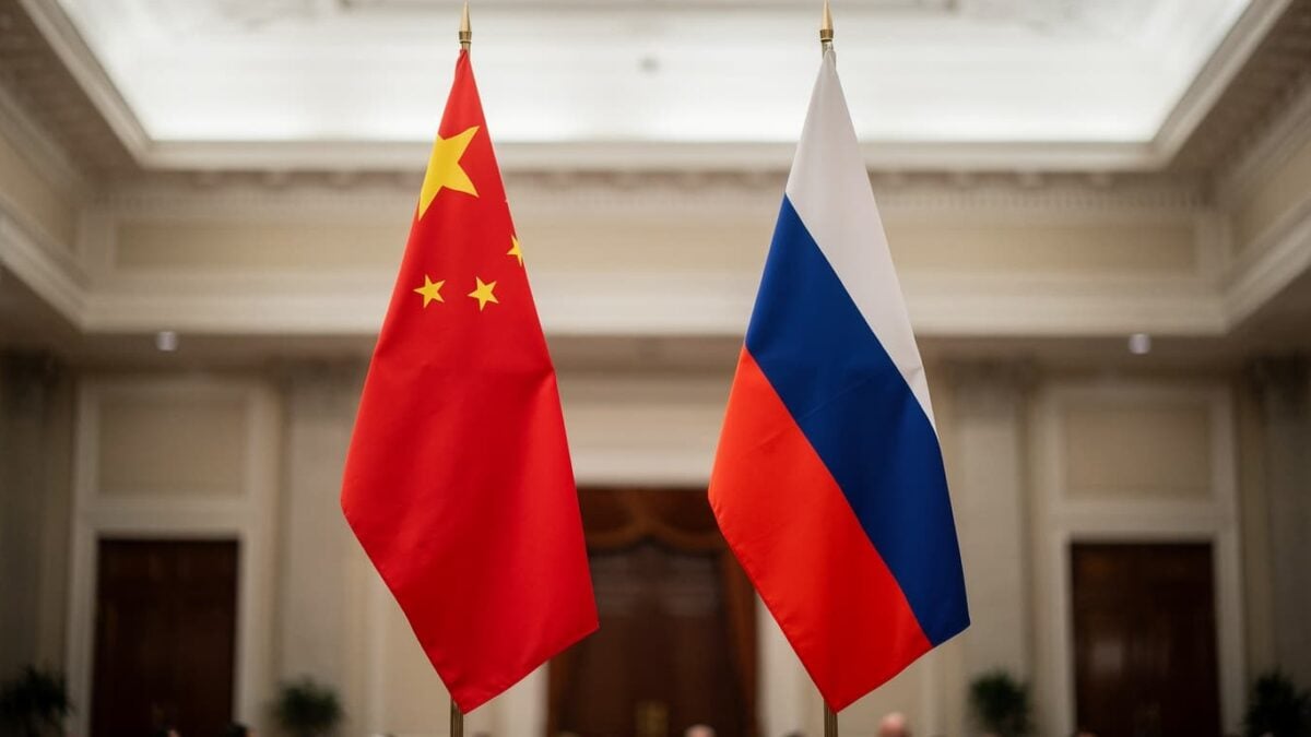 Chinese and Russian flags in a formal hall, symbolizing deepened bilateral ties