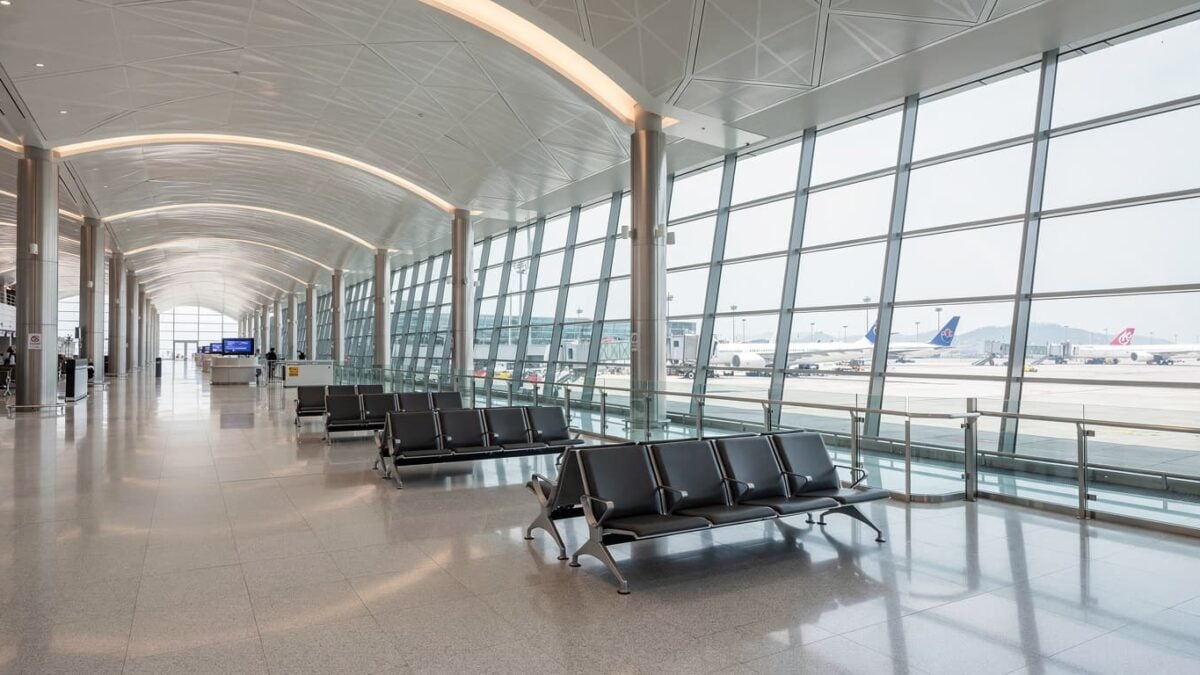 Hong Kong International Airport terminal interior with parked aircraft