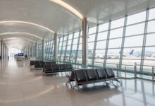 Hong Kong International Airport terminal interior with parked aircraft