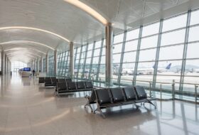 Hong Kong International Airport terminal interior with parked aircraft
