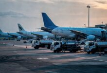 Jet planes and fuel trucks at a Southeast Asian airport