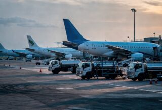 Jet planes and fuel trucks at a Southeast Asian airport