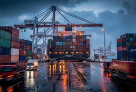 Container ships and cranes at Laem Chabang port, Thailand, at dusk