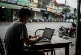 Young person with laptop in a cafe, Ho Chi Minh City