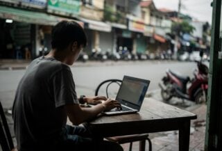 Young person with laptop in a cafe, Ho Chi Minh City