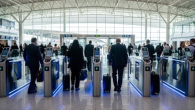 Automated immigration gates at Singapore Changi Airport, modern checkpoint with blue lighting and efficient passenger flow