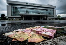 Bank Indonesia building with rupiah currency in foreground, Jakarta