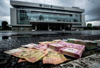 Bank Indonesia building with rupiah currency in foreground, Jakarta