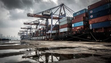 Busy container port in Mumbai, India, under an overcast sky