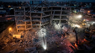Collapsed building construction site in Angeles City, Philippines, at dusk