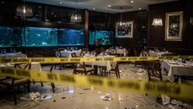 Crime scene in a Ho Chi Minh City restaurant with police tape and overturned furniture