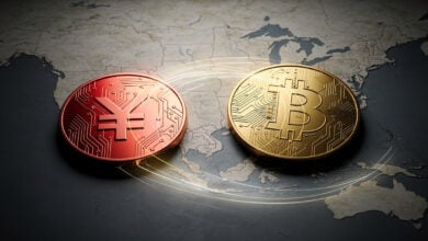 Digital yuan and Bitcoin logos over a map of East Asia and the US