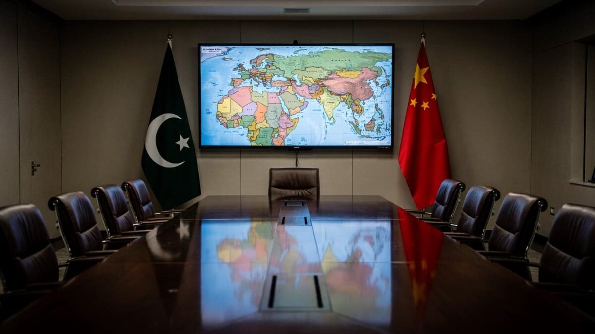 Diplomatic meeting room with Pakistani and Chinese flags, Middle East map on screen
