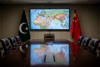 Diplomatic meeting room with Pakistani and Chinese flags, Middle East map on screen