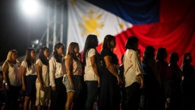 Diverse women on a stage under bright lights, representing Filipino identity