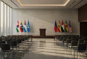 Empty conference podium with flags at diplomatic summit venue, Singapore