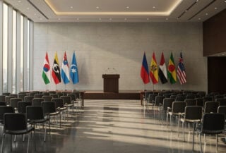 Empty conference podium with flags at diplomatic summit venue, Singapore
