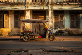 Empty tuk-tuk outside closed guesthouse, Siem Reap, Cambodia