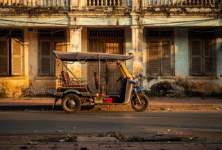 Empty tuk-tuk outside closed guesthouse, Siem Reap, Cambodia