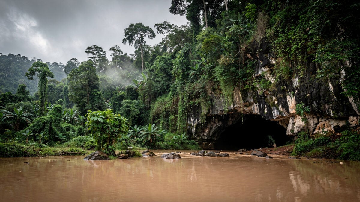 Flooded entrance of a karst cave in rural Laos jungle