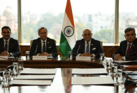 Formal diplomatic conference table, New Delhi, four-nation ministerial meeting, Indian flag