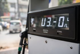 Fuel pump price display showing ₹103-104 per litre at Bengaluru petrol station, Karnataka