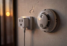 Hotel room power adaptor and smoke detector, Chinese interior, evening light