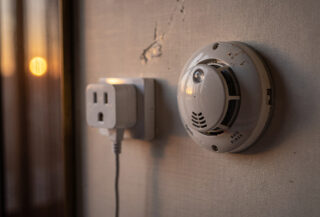 Hotel room power adaptor and smoke detector, Chinese interior, evening light