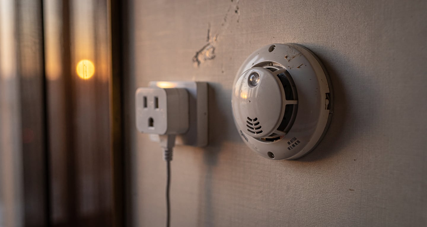 Hotel room power adaptor and smoke detector, Chinese interior, evening light
