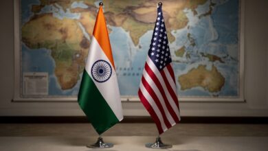 Indian and US flags with blurred map of Strait of Hormuz in background