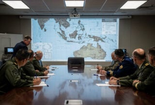 Pentagon war room with military officers reviewing Taiwan Strait strategic maps