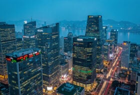 Seoul financial district skyline with illuminated office towers at dusk, aerial view