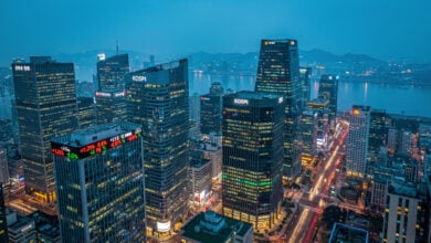 Seoul financial district skyline with illuminated office towers at dusk, aerial view