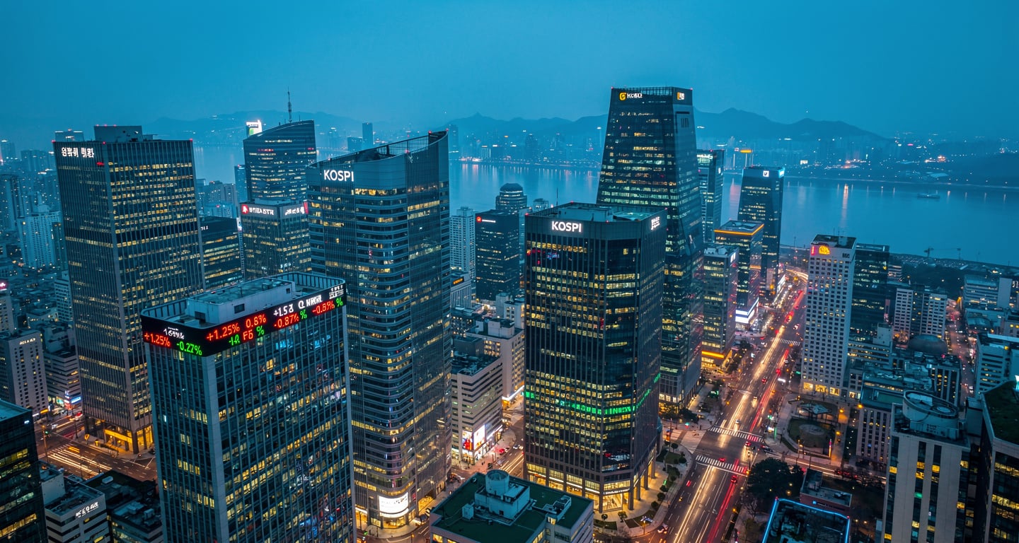 Seoul financial district skyline with illuminated office towers at dusk, aerial view