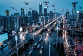 Shenzhen skyline with electric buses, taxis, and drone delivery infrastructure integrated into smart city streets