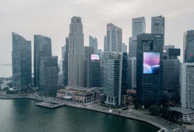 Singapore financial district skyline with modern office towers under overcast sky