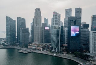 Singapore financial district skyline with modern office towers under overcast sky