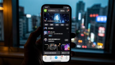Smartphone displaying Chinese streaming app with Taipei skyline in background