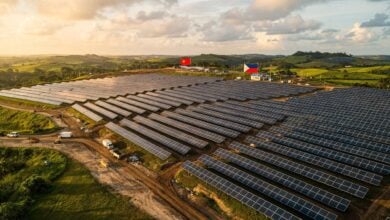 Solar panel field construction in rural Philippines, with flags in background