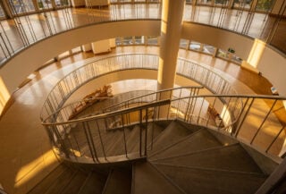 Spiral staircase ascending through multiple floors of Japanese retail building, Shibuya Tokyo