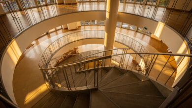 Spiral staircase ascending through multiple floors of Japanese retail building, Shibuya Tokyo