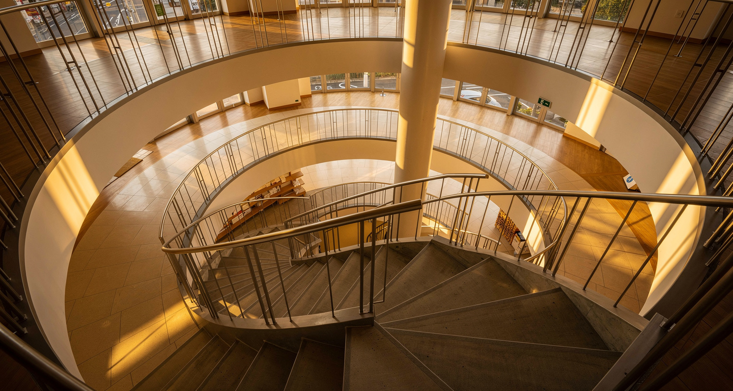 Spiral staircase ascending through multiple floors of Japanese retail building, Shibuya Tokyo