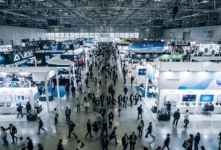Tech convention floor with booths and attendees, Taipei Nangang Exhibition Center