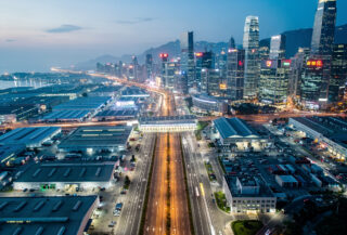 Aerial view of Shenzhen-Hong Kong border showing industrial and financial districts at dusk