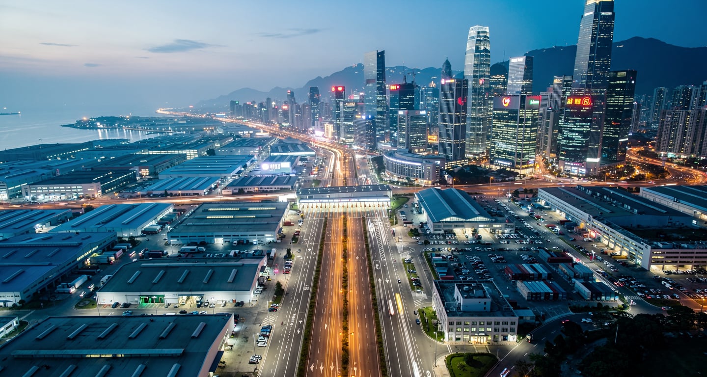 Aerial view of Shenzhen-Hong Kong border showing industrial and financial districts at dusk