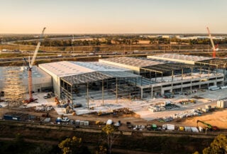 Aerial view of Western Sydney logistics estate under construction with M7 motorway in background